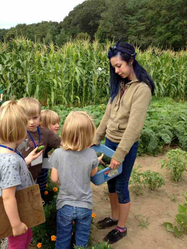 Sharing Cucumbers Teens and Preschoolers