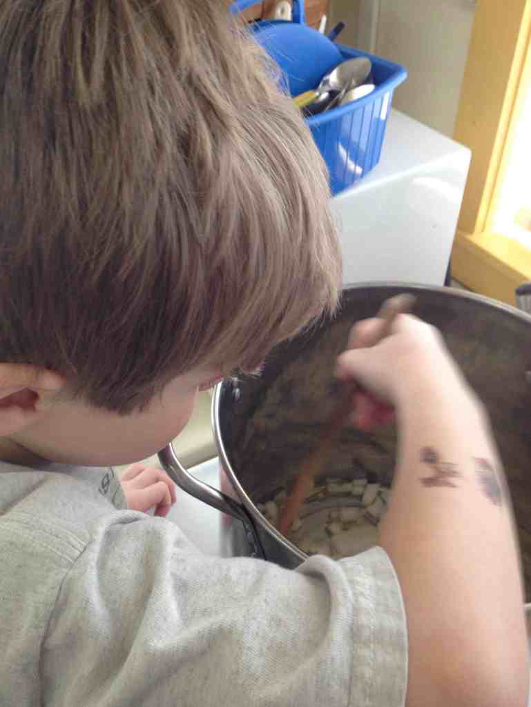 Stirring spinach potato soup