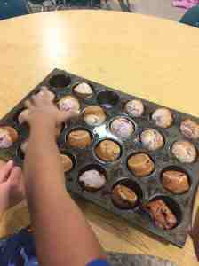 reaching for a raspberry muffin