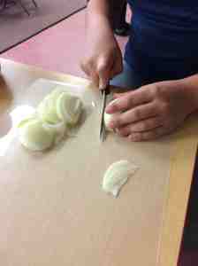 slicing onions for pizza topping