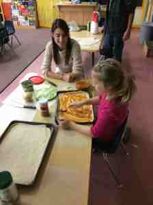 spreading tomato sauce