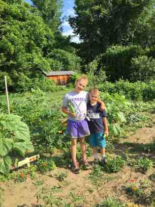 Nola and Sabin harvestting zukes